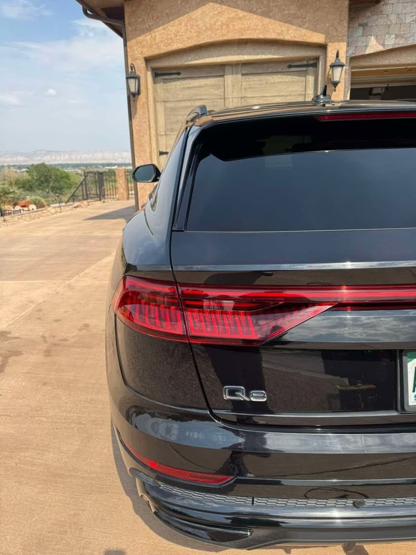 Back of a black Audi Q8 with glossy, spotless paint